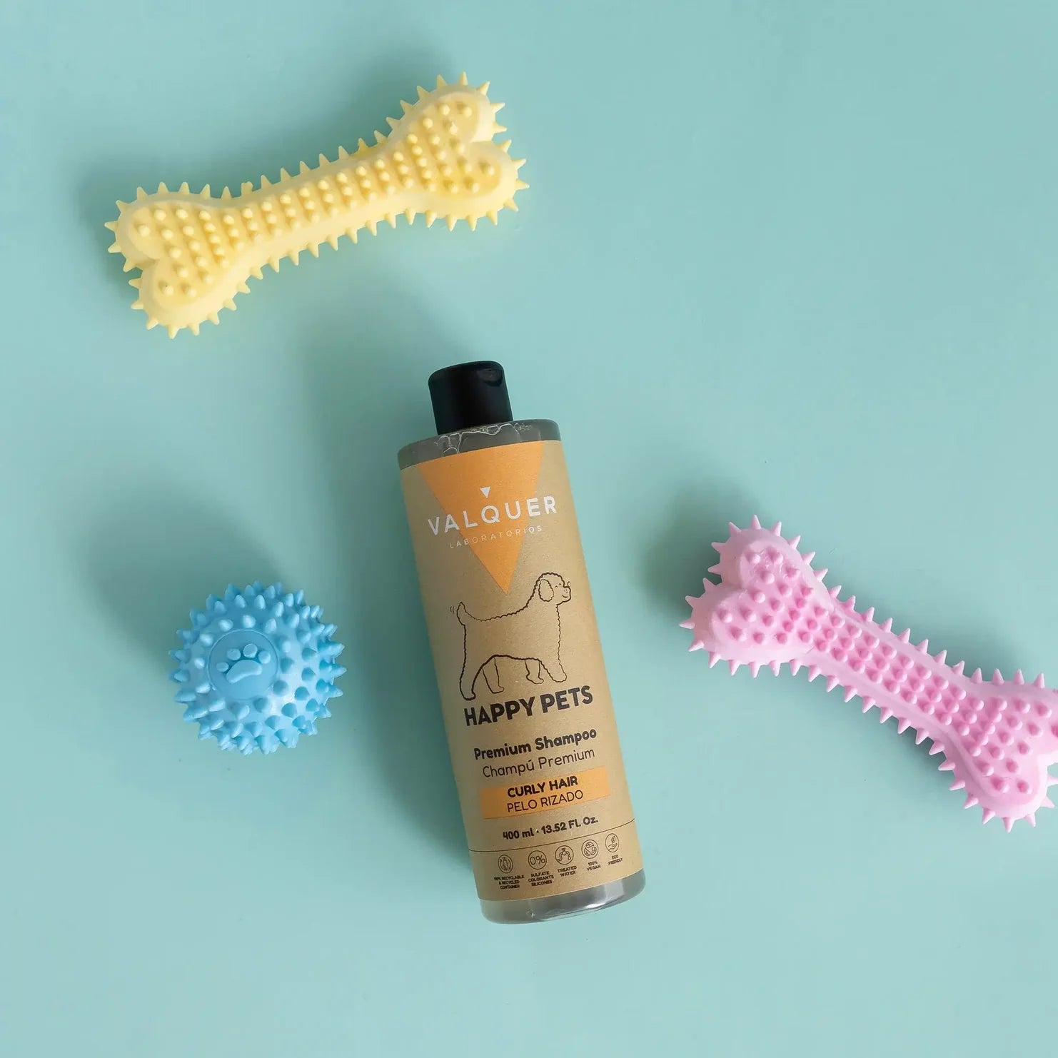 Primer plano del producto para el cuidado del pelaje rizado (Gama Curly M!mado) que muestra el resultado de rizos definidos, suaves y sin encrespamiento. Destaca que es 0% sulfatos, sales ni siliconas, reforzando la +CALIDAD y el cuidado natural. La solución ideal para que tu Mimado de pelaje rizado tenga un +VIDA con brillo y suavidad.